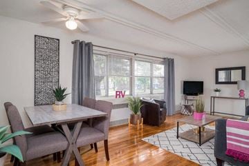 Tonawanda apartment for rent - A living room with a dining table and chairs.
