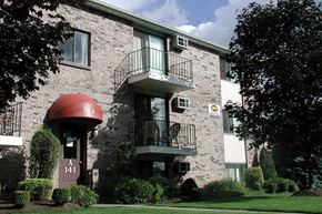 N. Tonawanda apartment for rent - a brick apartment building with a balcony and a red umbrella