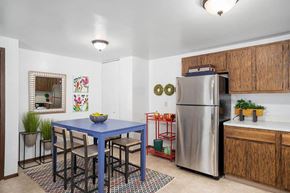 N. Tonawanda apartment for rent - a kitchen with a blue table and a stainless steel refrigerator