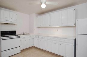 N. Falls apartment for rent - a kitchen with white cabinets and a stove and refrigerator