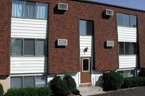 N. Falls apartment for rent - a dog sitting on the window of a brick building