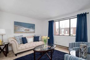 N. Falls apartment for rent - a living room with blue curtains and a couch and a table