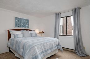 N. Falls apartment for rent - a bedroom with a bed and a large window