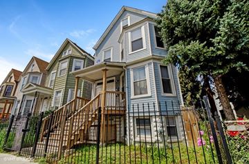 Chicago apartment for rent - a row of houses with a fence in front of them