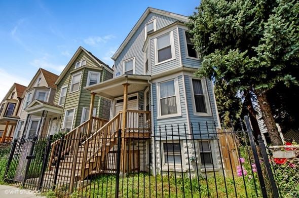 Chicago apartment for rent - a row of houses with a fence in front of them