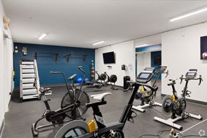 Orlando apartment for rent - a gym with cardio equipment and weights in a building