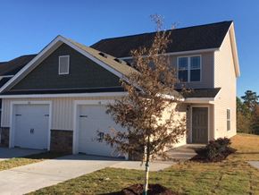 Clayton apartment for rent - a house with two garage doors and a tree in front of it