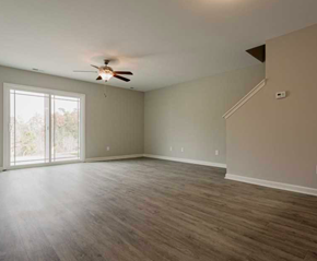 Clayton apartment for rent - an empty living room with a ceiling fan