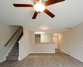 Clayton apartment for rent - an empty living room with a ceiling fan and a staircase