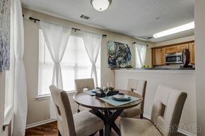 Denver apartment for rent - a dining room with a table and chairs and a kitchen