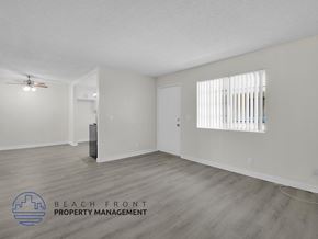 Long Beach apartment for rent - A spacious room with a ceiling fan and a window with blinds.