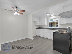 Long Beach apartment for rent - A kitchen with a black dishwasher and a ceiling fan.