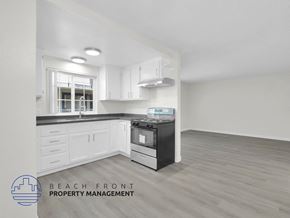 Long Beach apartment for rent - A kitchen with a stove top oven and a window.