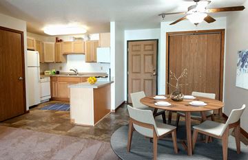 Rochester apartment for rent - A kitchen with a table and chairs in the middle of the room.
