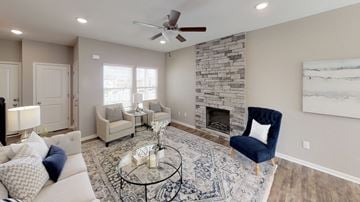 Shawnee triplex for rent - a living room with a couch and a chair and a fireplace