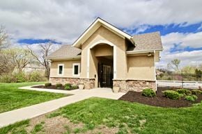 Shawnee triplex for rent - a house with grass and a sidewalk in front of it