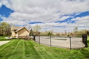 Shawnee triplex for rent - the view of a pool and a house with a fence