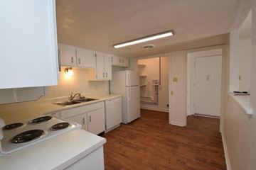 Knoxville apartment for rent - A kitchen with white cabinets and a stove top oven.