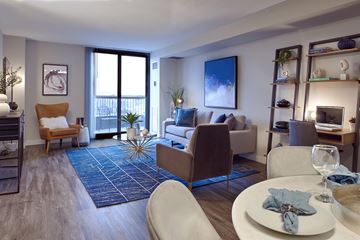 Edina apartment for rent - A modern living room with a dining table set for two.