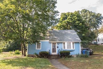 Hamden apartment for rent - a small blue house on a hill with trees