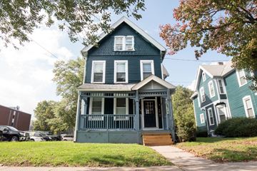 New Haven apartment for rent - A blue house with a porch and a tree in front.