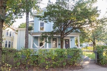 New Haven apartment for rent - A blue house with a tree in front of it.