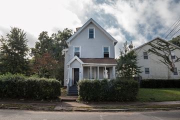 Hamden apartment for rent - A white house with a grey roof and a small porch.