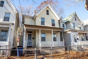 New Haven apartment for rent - A house with a grey roof and a white fence.