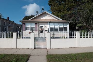 New Haven apartment for rent - A white house with a red door and a white fence.