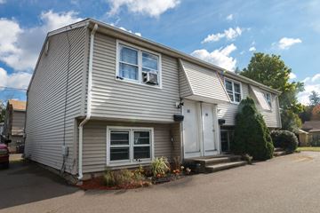 New Haven apartment for rent - A two-story house with a grey exterior and white trim.