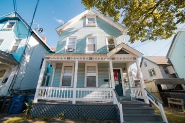 New Haven apartment for rent - A blue house with a white porch and a red door.