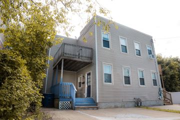 New Haven apartment for rent - A grey house with a blue staircase.