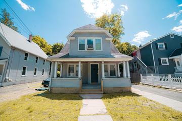 New Haven apartment for rent - A house with a grey roof and a white fence in front.