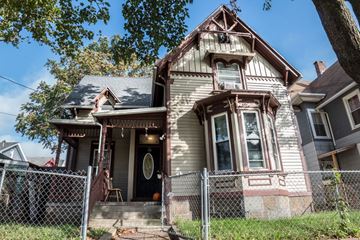 New Haven apartment for rent - A house with a brown roof and a white fence.