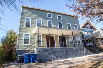 New Haven apartment for rent - A house with a grey facade and a brown roof.