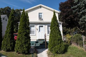 New Haven apartment for rent - A white house with a green front door and steps.