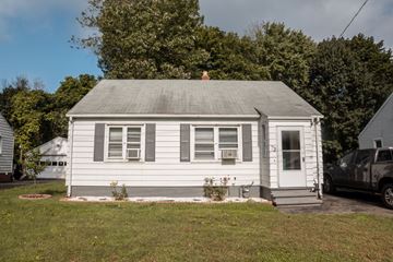 Hamden apartment for rent - A small white house with a grey roof and a black truck parked in front.