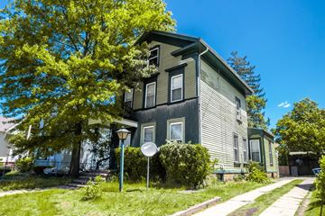 New Haven apartment for rent - A house with a green lawn and a tree in front.