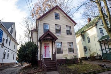 New Haven apartment for rent - A house with a red door is in the center of the image.