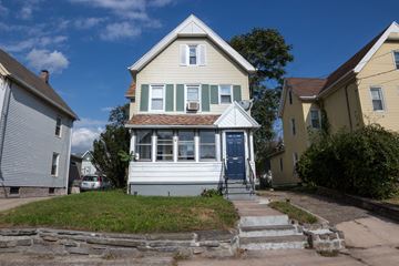 West Haven apartment for rent - A two-story house with a blue door and white trim.
