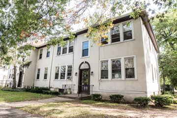 New Haven apartment for rent - A white house with a black door and windows surrounded by trees.