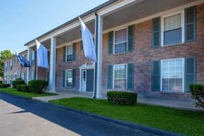 Columbia apartment for rent - the front of a brick building with blue flags