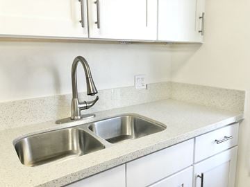 Los Angeles apartment for rent - a kitchen sink with white cabinets and a faucet