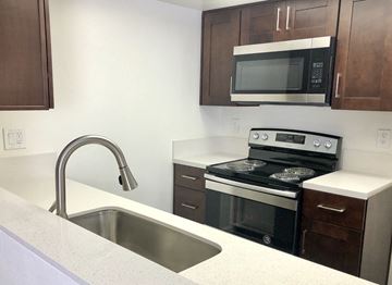 Hollywood apartment for rent - a kitchen with a sink and a stove and a microwave