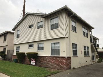 Van Nuys apartment for rent - a white house with a sign in front of it