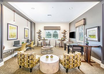 Orlando apartment for rent - a living room with chairs and tables and a television