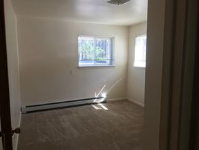 Lansing apartment for rent - A room with a window and a fan.