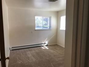 Lansing apartment for rent - A room with a carpeted floor and a window.