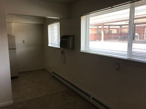 Lansing apartment for rent - A room with a window and a wall-mounted air conditioner unit.