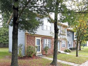 Monroe townhouse for rent - a blue house with trees in front of it